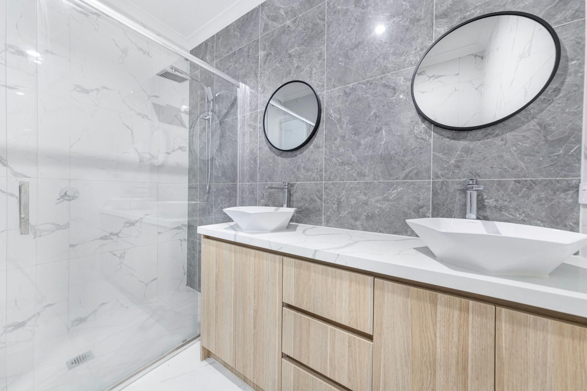 Bathroom with a double vanity and a glass walk-in shower